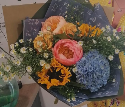 Spring Garden Bouquet - Gentle pastel tones blend beautifully with touches of warm sunshine hues, creating a balanced and elegant look. The mix of full, rounded shapes and airy accents adds depth and texture, while the decorative wrap enhances its refined, contemporary charm. Perfect for heartfelt gifting or bringing a calm, uplifting presence to any setting.