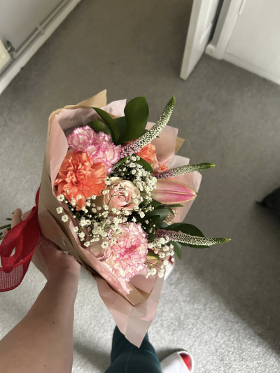 Soft Garden - A charming and delicate hand-tied posy, perfectly sized for a thoughtful gesture. Soft blush and peach tones are paired with airy whites and fresh greenery, creating a light and romantic feel. The compact design is full of texture and gentle movement, giving it a natural, just-picked look. Finished with soft wrapping and a ribbon detail, this petite arrangement is perfect for small celebrations, thank-yous, or simply brightening someone’s day.