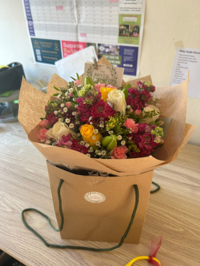 Country Charm - A charming gift bag filled with a fresh mix of seasonal blooms, beautifully arranged to brighten any occasion.